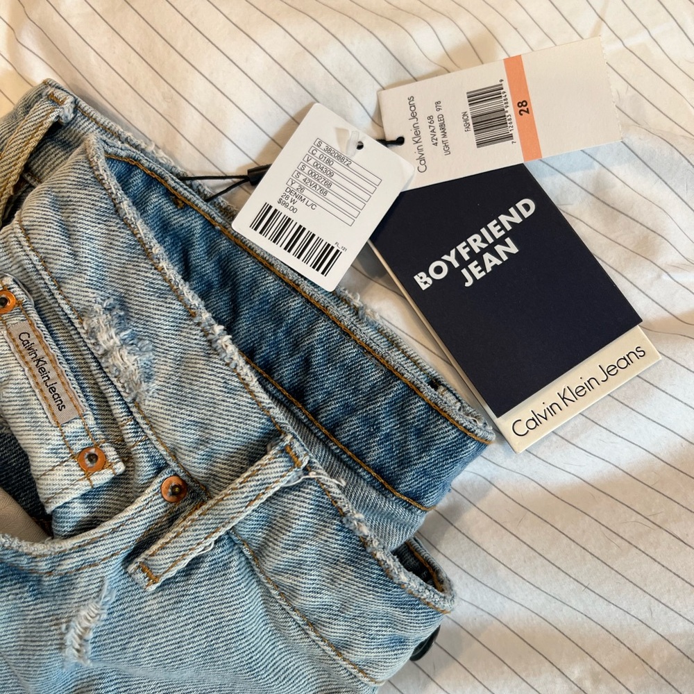 Calvin Klein Jeans, distressed boyfriend style. Size 28 never worn tags still on